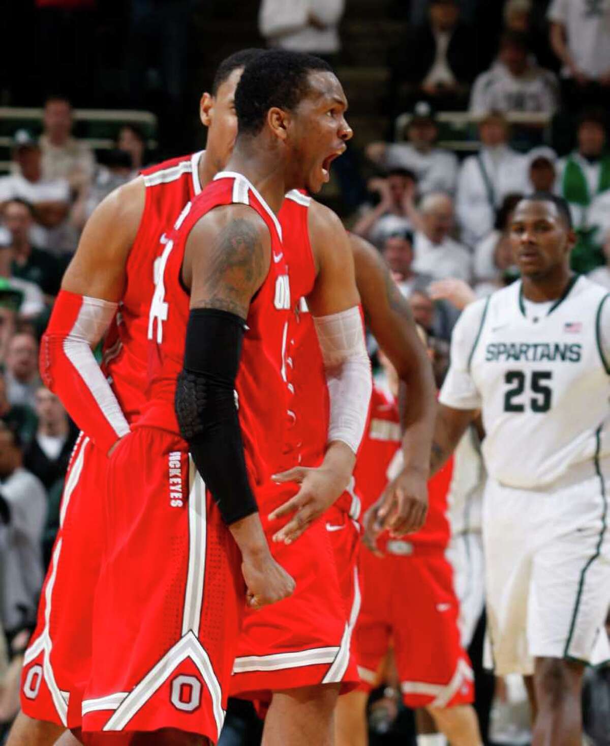 A jumper by William Buford (front) with one second remaining gave No. 10 Ohio State a 72-70 win over Michigan State.