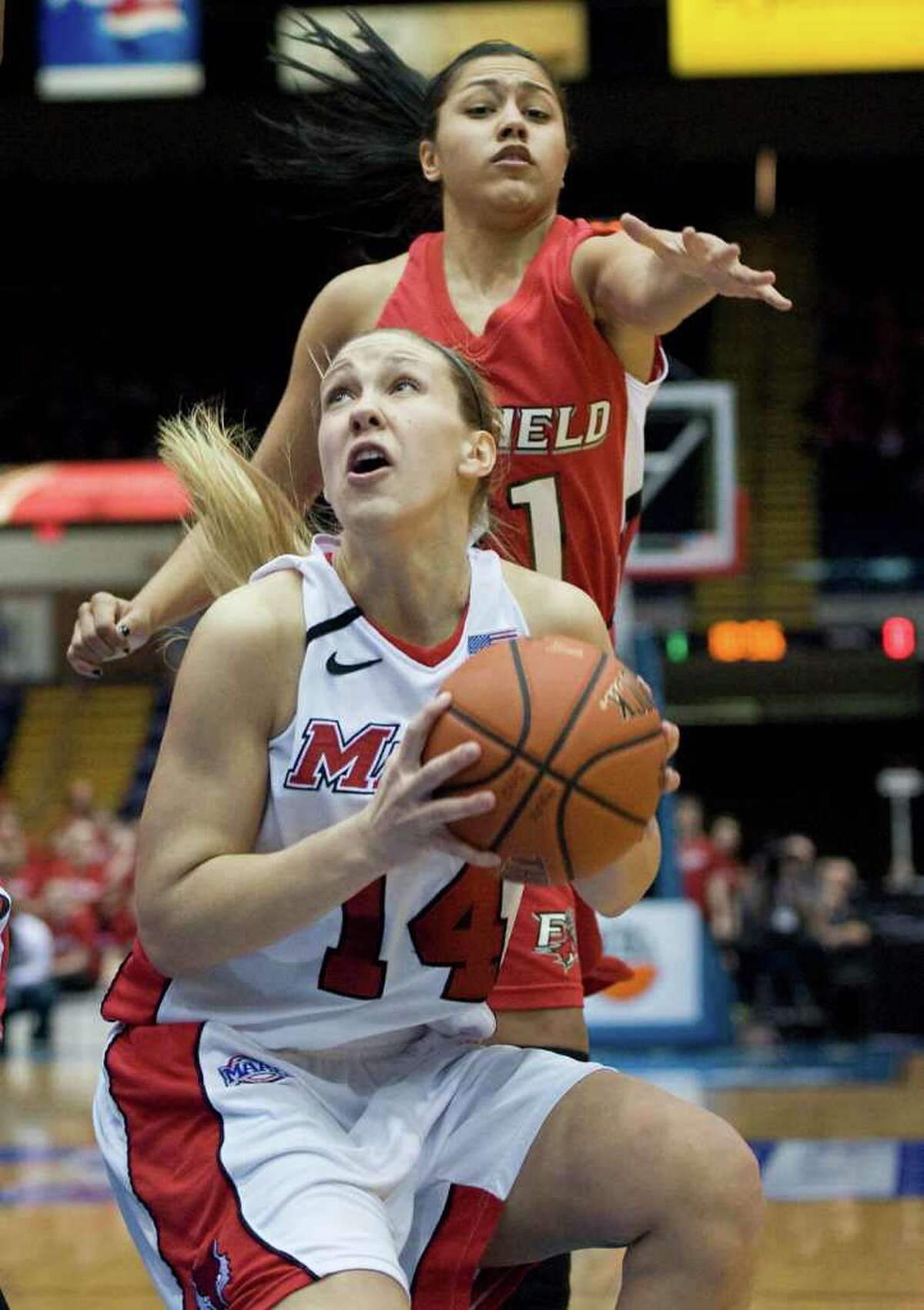 Marist's Casey Dulin, bottom, is guarded by Fairfield's Desiree Pina, top in the first half of an NCAA college basketball game for the championship of the Metro Atlantic Athletic conference women's tournament in Springfield, Mass., Monday, March 5, 2012. (AP Photo/Jessica Hill)