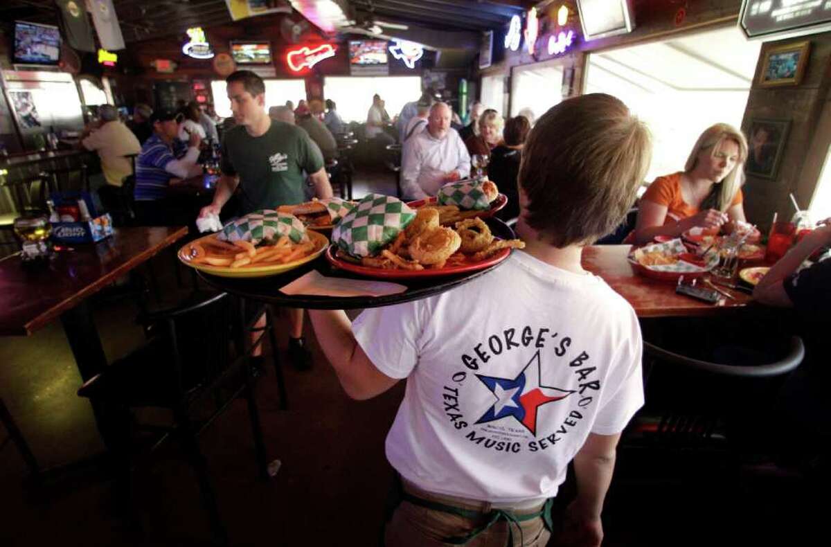 In this March 3, 2012 photo, Ben Morgan, an employee at George's restaurant delivers an order, in Waco, Texas. U.S. service companies expanded in February at the fastest pace in a year, helped by a rise in new orders and job growth. (AP Photo)