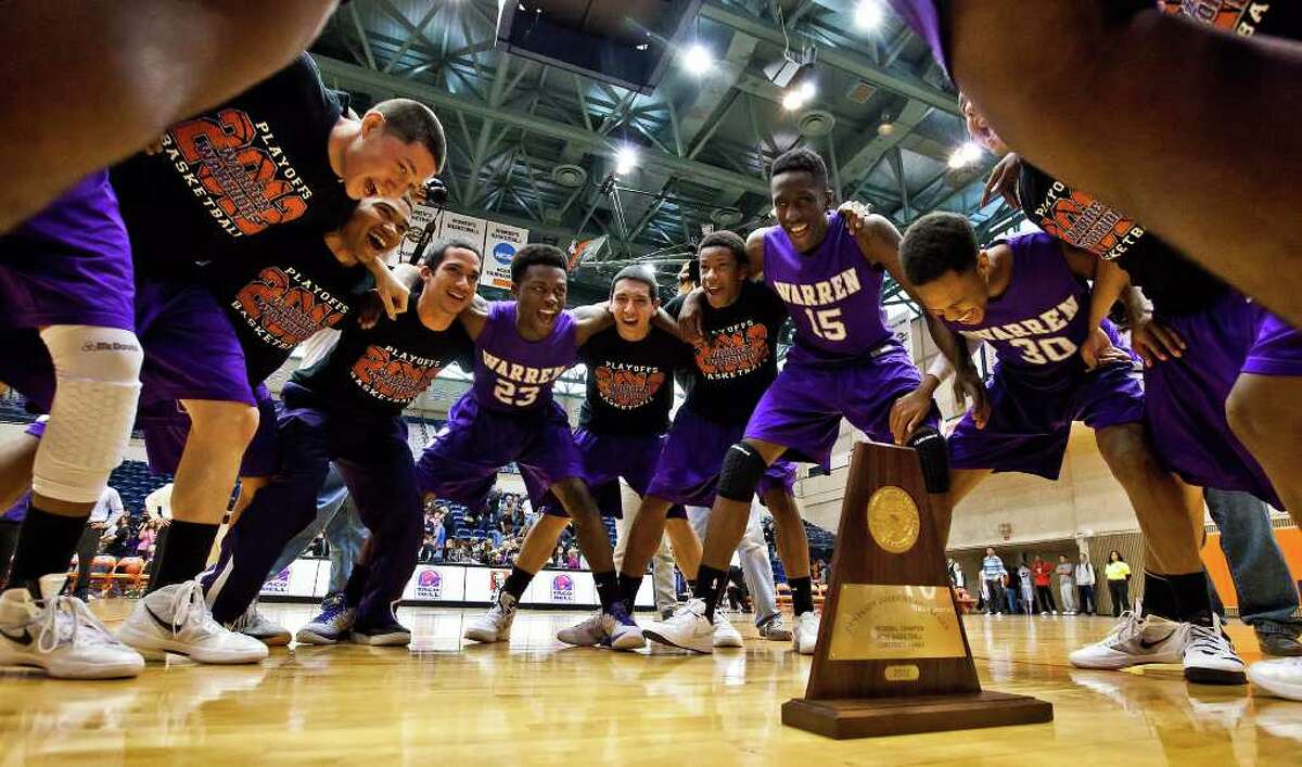 Warren basketball players celebrate around their Regional Champion trophy during the Region IV-5A boys basketball finals at the UTSA Convocation Center on March 3, 2012. Warren defeated Clark 65-56 to advance to the state tournament in Austin. Photo by Marvin Pfeiffer / Prime Time Newspapers