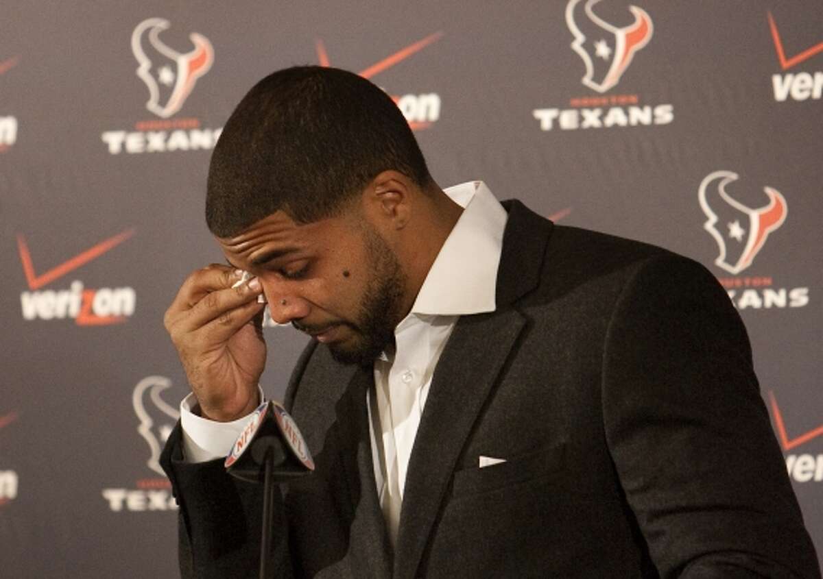 Texans running back Arian Foster wipes tears from his eyes during a news conference announcing his new contract in 2012. Foster spoke about one of the toughest times in his life, when his mom had to pawn her wedding ring to put food on the table. The press conference came after he agreed to a five-year, $43.5 million deal with the Texans. Take a look back at Foster through his Texans career. (Cody Duty / Houston Chronicle)