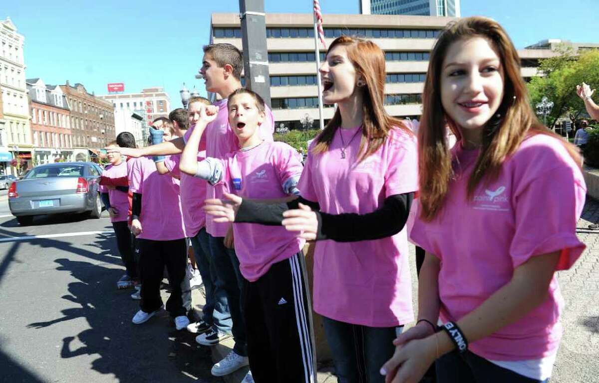 Family members, friends and survivors gather along Atlantic Street to create a “Mile of Pink” in downtown Stamford. The third annual “Mile of Pink” is a 90-minute show of unity and a demonstration of breast cancer awareness. The event kicks off Stamford Hospital’s month-long annual “Paint the Town Pink” campaign in Stamford, Conn. on Saturday October 2, 2010.