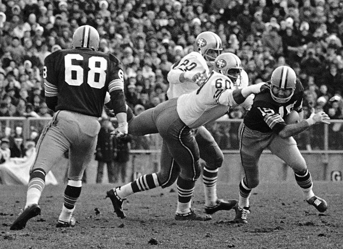 FILE - In this Nov. 19, 1967, file photo, Green Bay Packers quarterback Bart Starr (15) is caught behind the line of scrimmage by San Francisco 49ers' Roland Lakes (60) during an NFL football game in Green Bay, Wis. The 49ers say Lakes has died. He was 72. The team said Lakes died Monday, March 5. A second-round draft pick by San Francisco in 1961 out of Wichita State, Lakes had until 2010 been the 49ers' youngest starting lineman in team history at 21 years, 11 months and 24 days when he played as a rookie in 1961. (AP Photo/File)