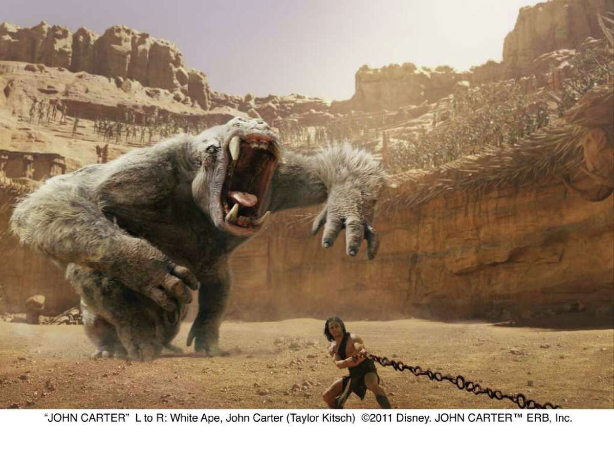 "JOHN CARTER" L to R: White Ape, John Carter (Taylor Kitsch) 2011 Disney. JOHN CARTER(TM) ERB, Inc.