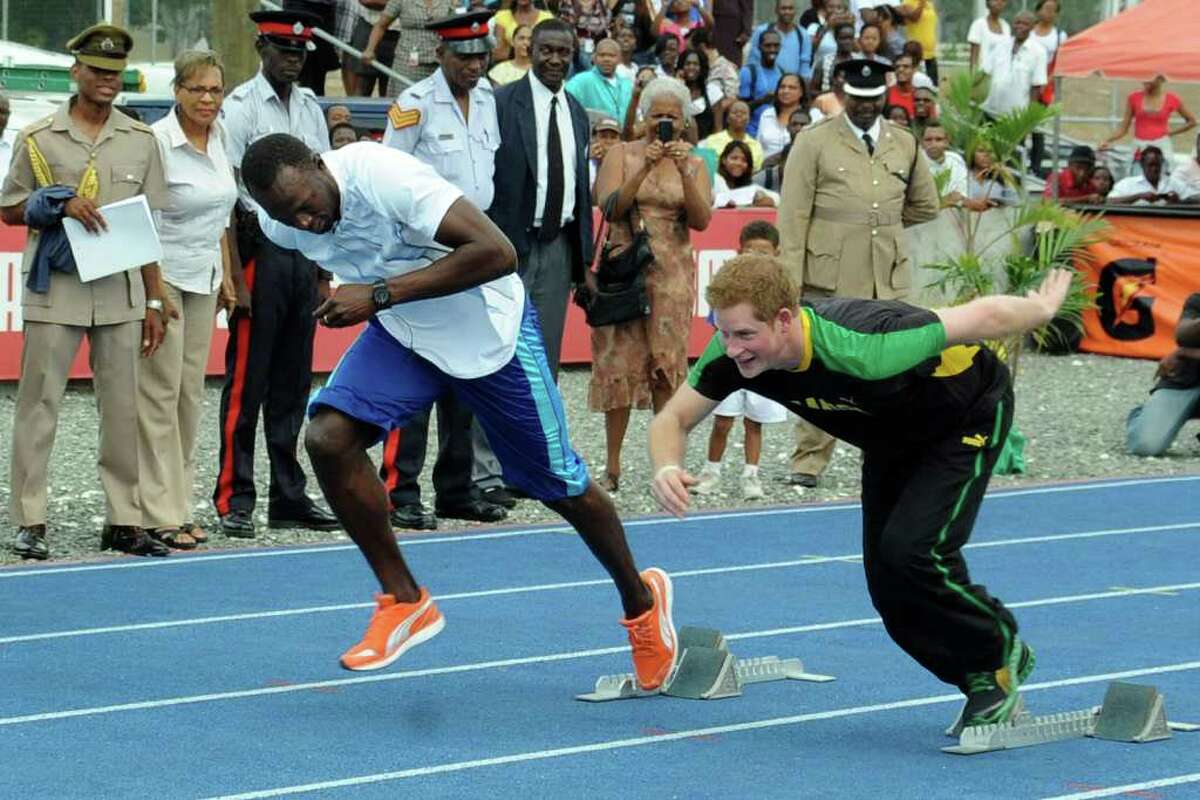 Britain's Prince Harry, right, and Olympic sprint champion Usain Bolt run during a mock race in Kingston, Jamaica, Tuesday March 6, 2012. The Prince is in Jamaica as part of the Diamond Jubilee tour in honor of Queen Elizabeth II who celebrates 60 years on the throne. His visit comes as the new prime minister, Portia Simpson Miller, has called anew for the severing of ties with the British monarchy. (AP Photo/Collin Reid)