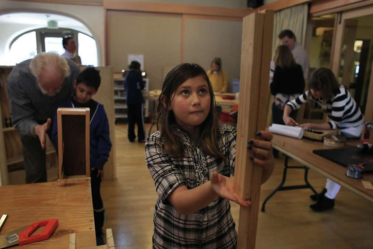 Marissa Burke, 9, lines up boards she will saw to make a slit drum during the musical instrument building class at The Berkeley School on Wednesday, February 29, 2012 in Berkeley, Calif.