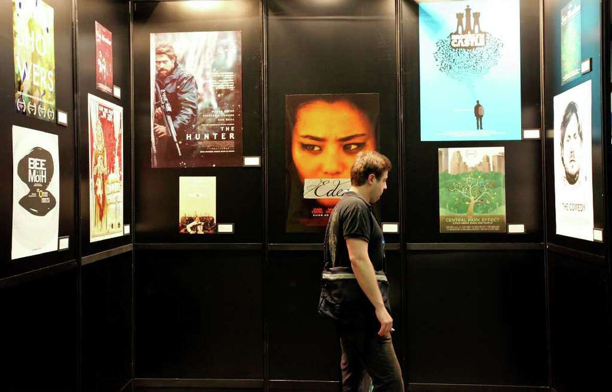 Andrew Fuller, producer of the film “Brute Force,” looks at film posters at the Austin Convention Center.