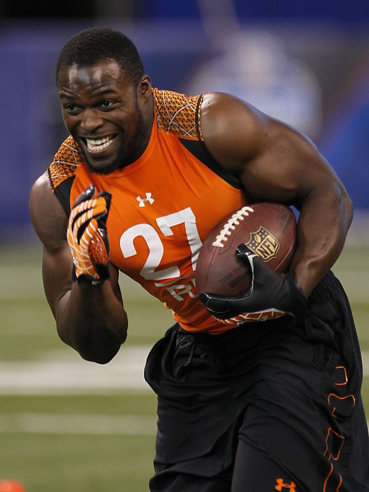 Utah State running back Robert Turbin runs a drill at the NFL football scouting combine in Indianapolis on Sunday, Feb. 26, 2012. (AP Photo/Dave Martin)