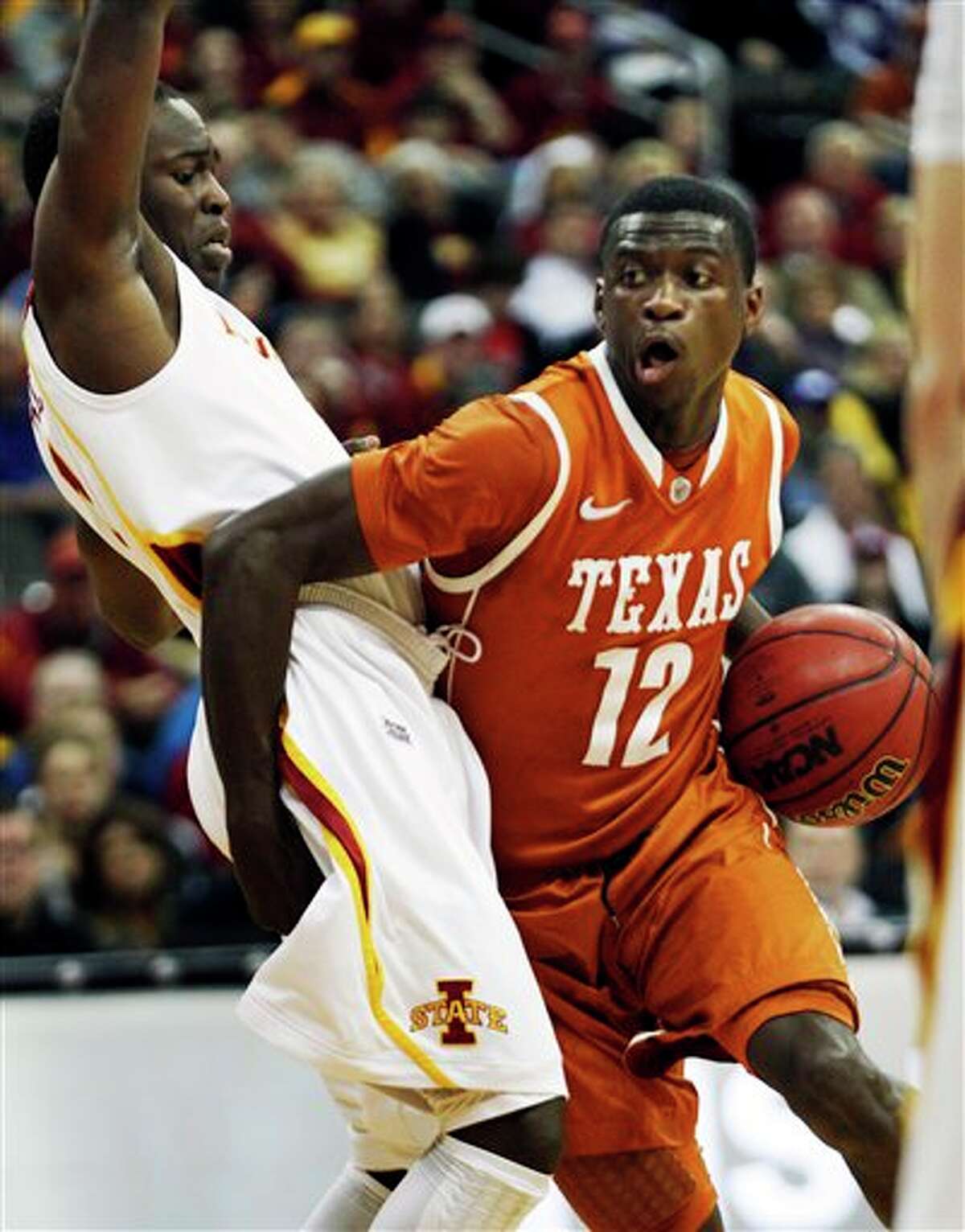 Texas guard Myck Kabongo (12) gets around Iowa State guard Bubu Palo (1) during the first half of an NCAA college basketball game in the Big 12 Basketball Tournament Thursday, March 8, 2012, in Kansas City, Mo.