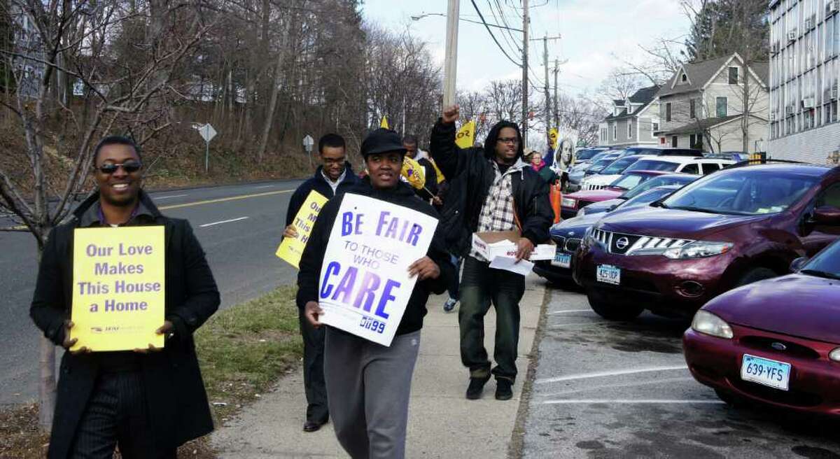 Members of New England Health Care Employees Union, District 1199, picket Friday outside the Westport Health Care Center to protest impasse in negotiating a new contract with HealthBridge, the company that manages the nursing home.