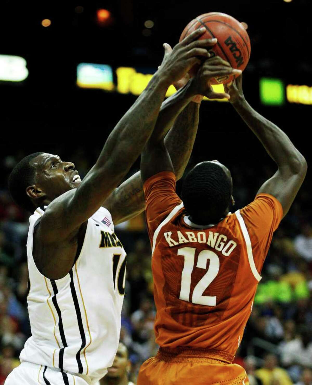 Missouri forward Ricardo Ratliffe (10) battles for a rebound with Texas guard Myck Kabongo (12) during the first half of an NCAA college basketball game in the Big 12 Conference tournament Friday, March 9, 2012, in Kansas City, Mo.