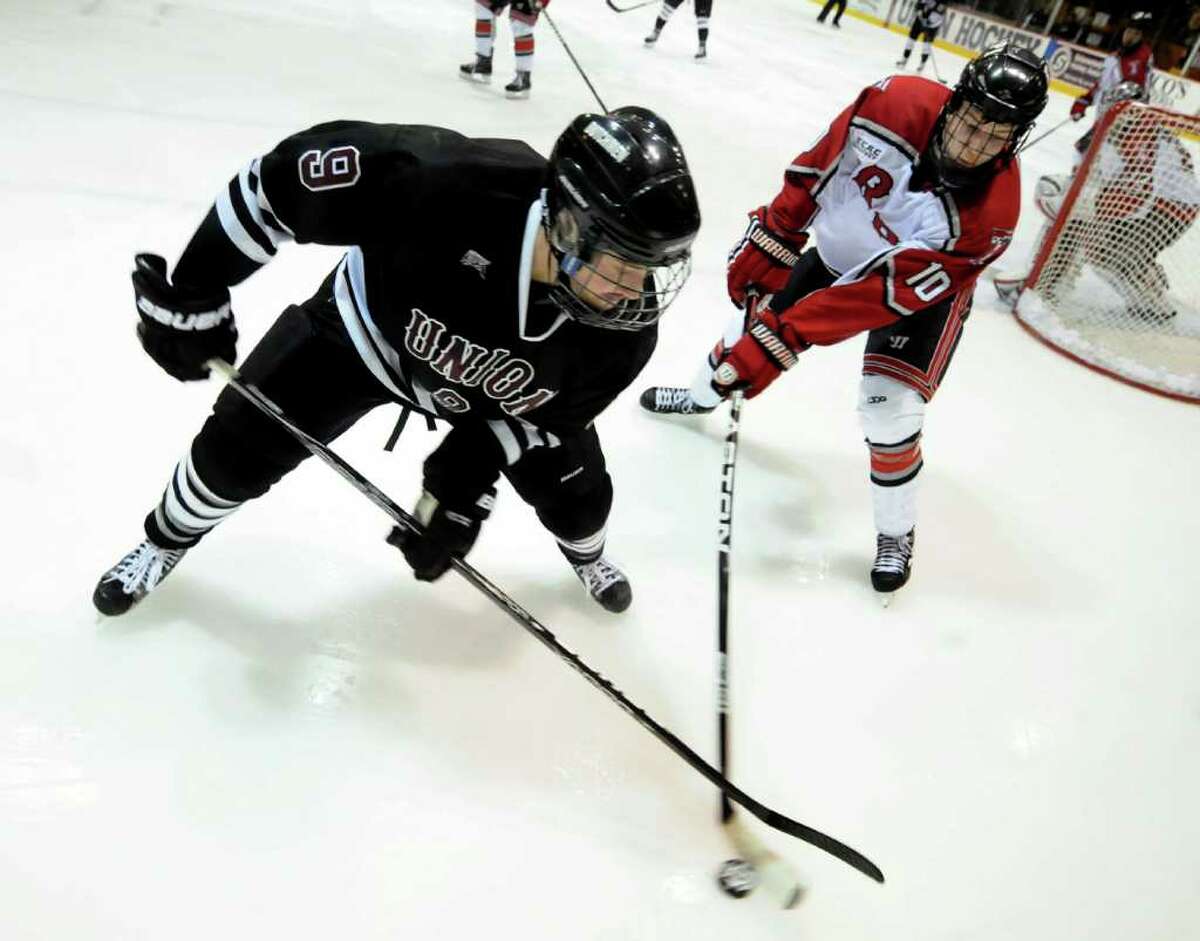 Union's Daniel Carr (9), left, and RPI's Curtis Leonard (10) battle for the puck during the first ECAC quarterfinal hockey game on Friday, March 9, 2012, at Union College in Schenectady, N.Y. (Cindy Schultz / Times Union)