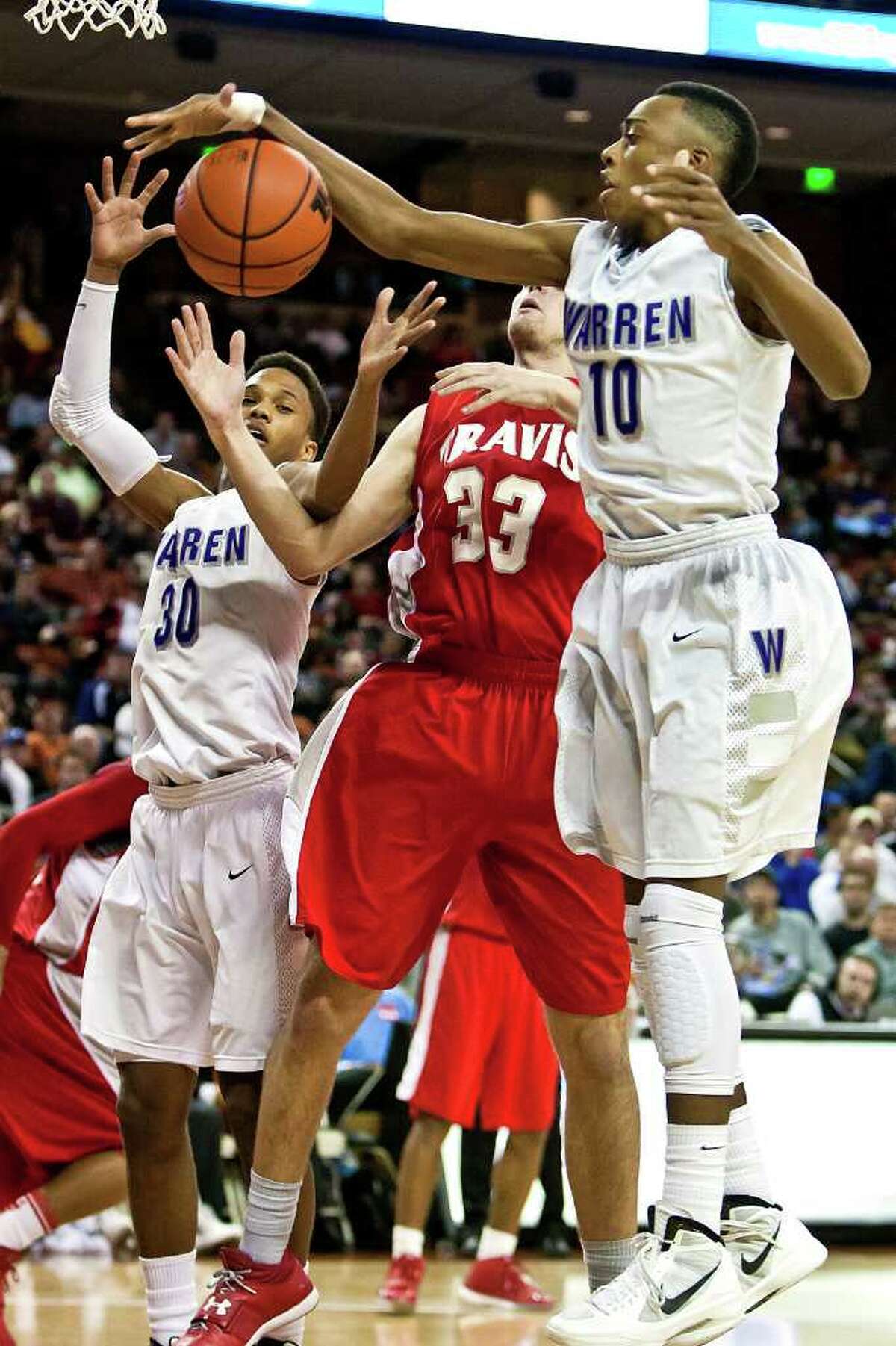 Warren's Pris Collins (right) and Jerell Ellis fight for a fourth quarter rebound with Fort Bend Travis's Kyle Coulter during their 5A state semifinal game at the Frank Erwin Center in Austin on March 9, 2012. MARVIN PFEIFFER/ mpfeiffer@express-news.net
