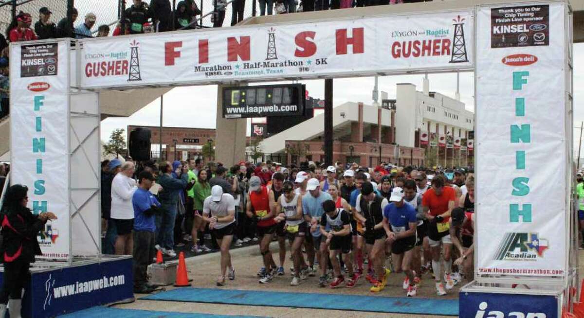 Runners participate in the Gusher Marathon, Half Marathon and 5K race in Beaumont on Saturday. Kevin Daigle/The Enterprise