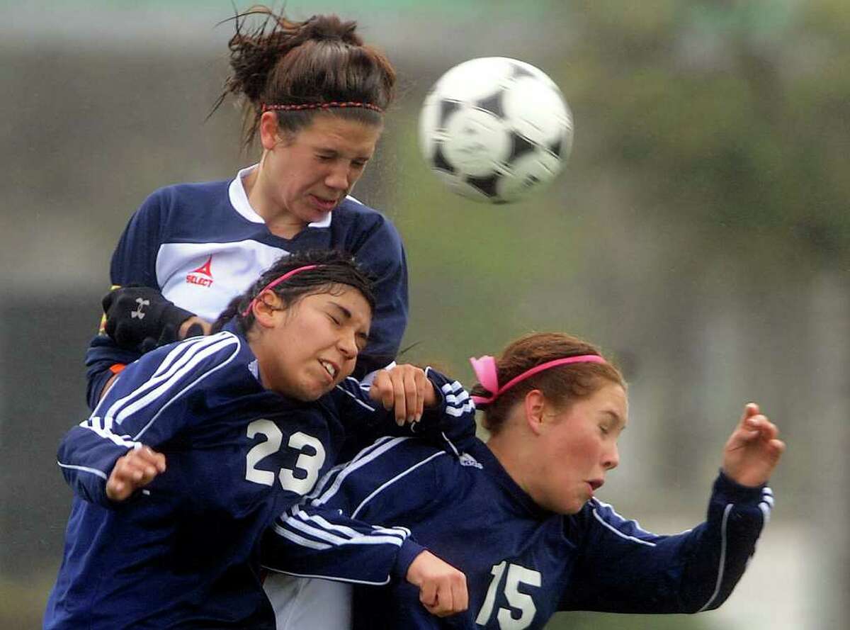 Lisa Tomenendal, top, of Brandeis, battles Alexis Alaniz (23) and Lauren McKenzie (15) of O'Connor during girls soccer action at Farris Stadium on Saturday, March 10, 2012. Billy Calzada / San Antonio Express-News