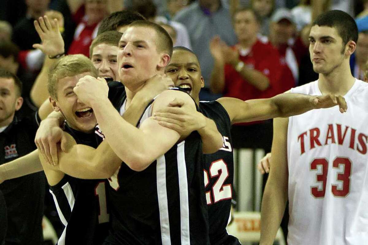Fort Bend Travis forward Kyle Coulter (33) can only watch as Lewisville Marcus guard Phil Forte (10) celebrates with A.J. Luckey (11), left, and Michael Wheeler (22) after after their victory in UIL class 5A state championship high school basketball game at the Erwin Center on Saturday, March 10, 2012, in Austin. Lewisville Marcus won the game 56-52.