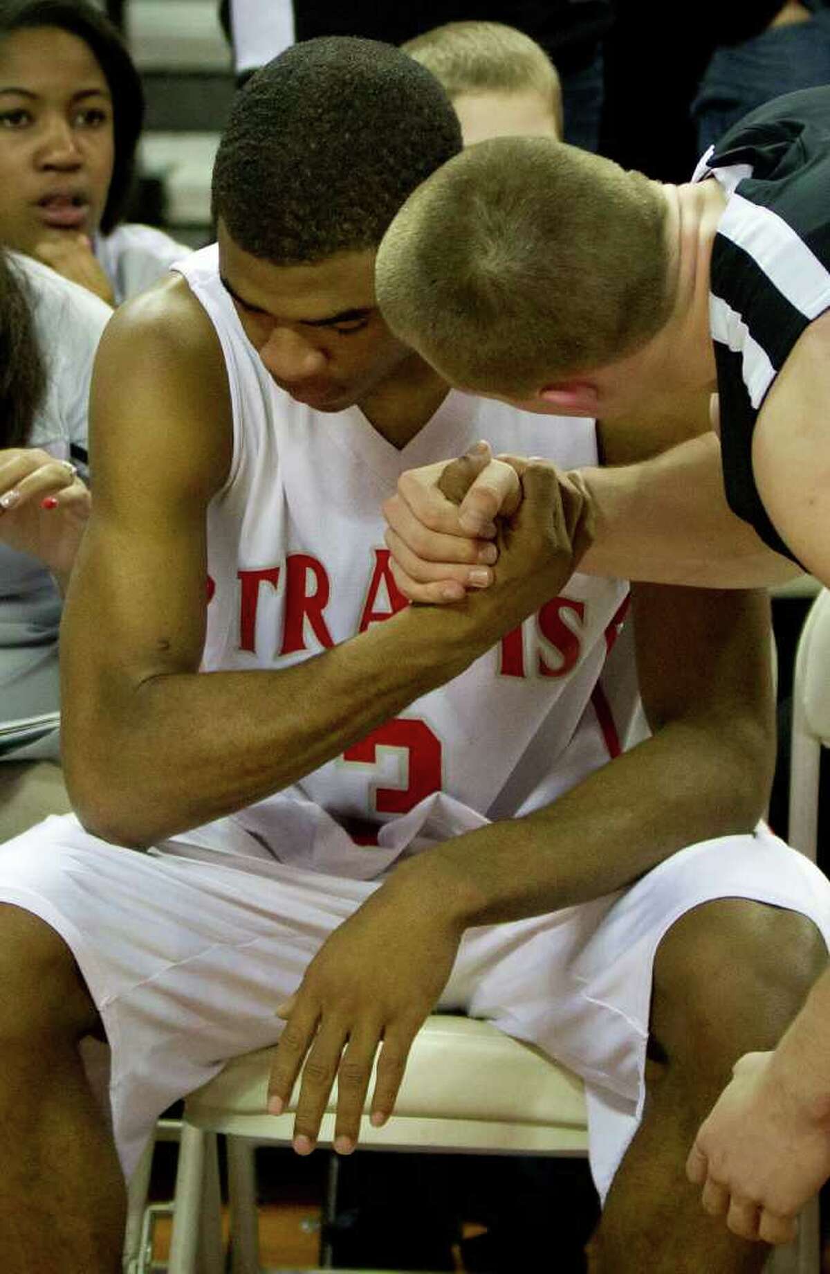 Fort Bend Travis guard Aaron Harrison is consoled by Lewisville Marcus guard Phil Forte after Marcus defeated Travis to win the UIL class 5A state championship high school basketball game at the Erwin Center on Saturday, March 10, 2012, in Austin. Lewisville Marcus won the game 56-52.