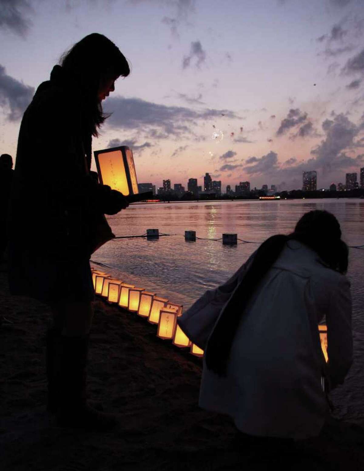 People place lanterns on the sea to commemorate the one-year anniversary of the Great East Japan Earthquake and Tsunami in Tokyo.