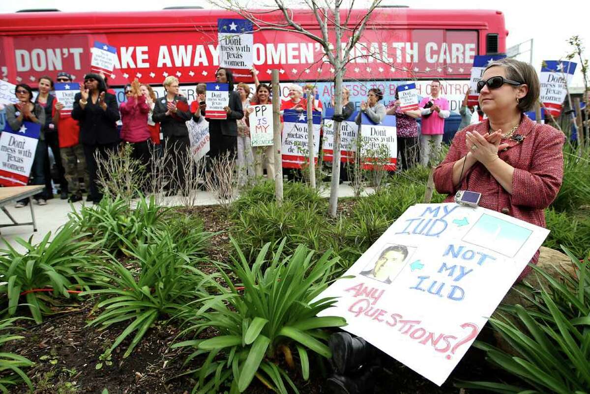 With her sign in tow, Andrea Greer was among about 300 who rallied Monday at Planned Parenthood's Houston headquarters.