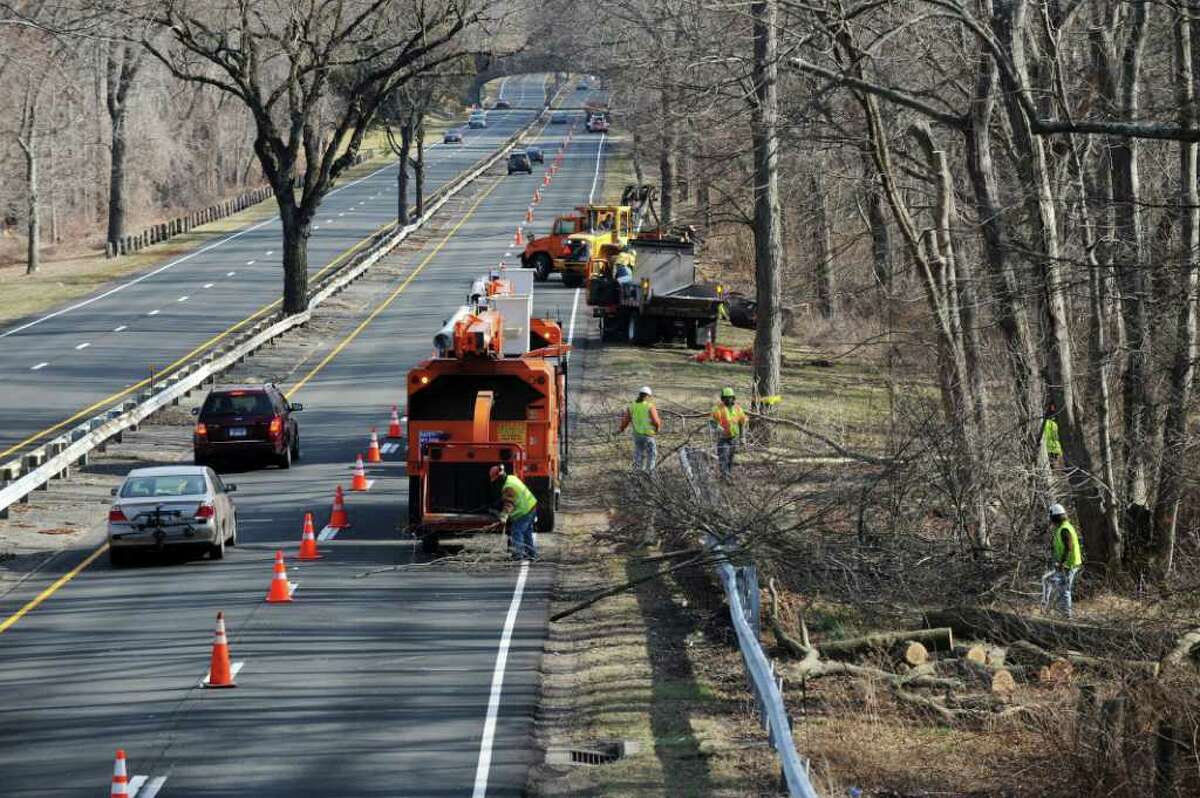 Conn. State Department of Transportation workers trim trees along the Merritt Parkway N just north of the Merwin's lane overpass in Fairfield, Conn. on Monday, march 12, 2012.
