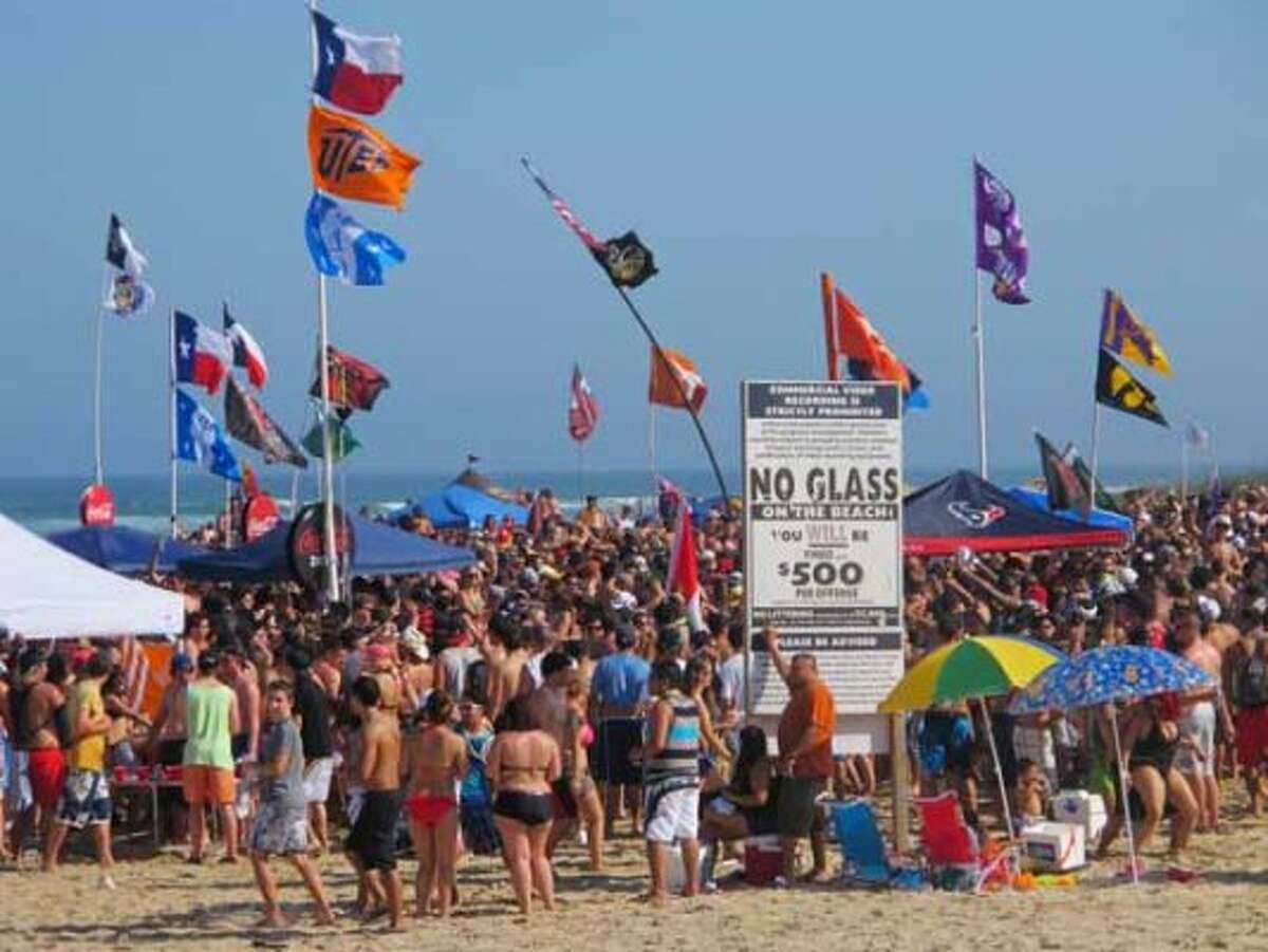 Spring breakers pack Coca-Cola Beach in South Padre Island on March 12, 2012. Guests from Isla del Sol condominiums next door can watch 10,000 students cover the beach during Texas week when the state's schools are on break. City officials say hotel occupancy is at 95 percent for Texas week. (Chris Sherman / Associated Press)