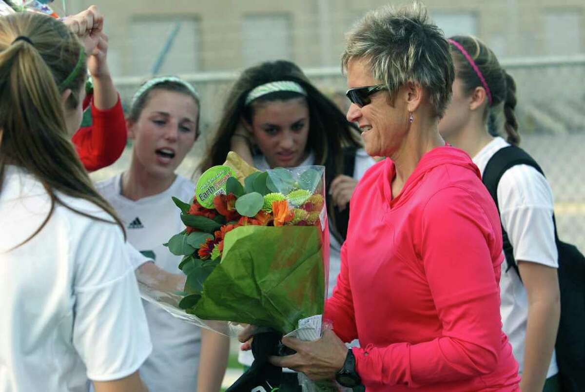 Players present flowers after coach Frankie Whitlock gets her 500th victory as the Reagan girls defeat Madison 7-0 at Blossom Soccer Stadium on March 13, 2012 Tom Reel/ San Antonio Express-News