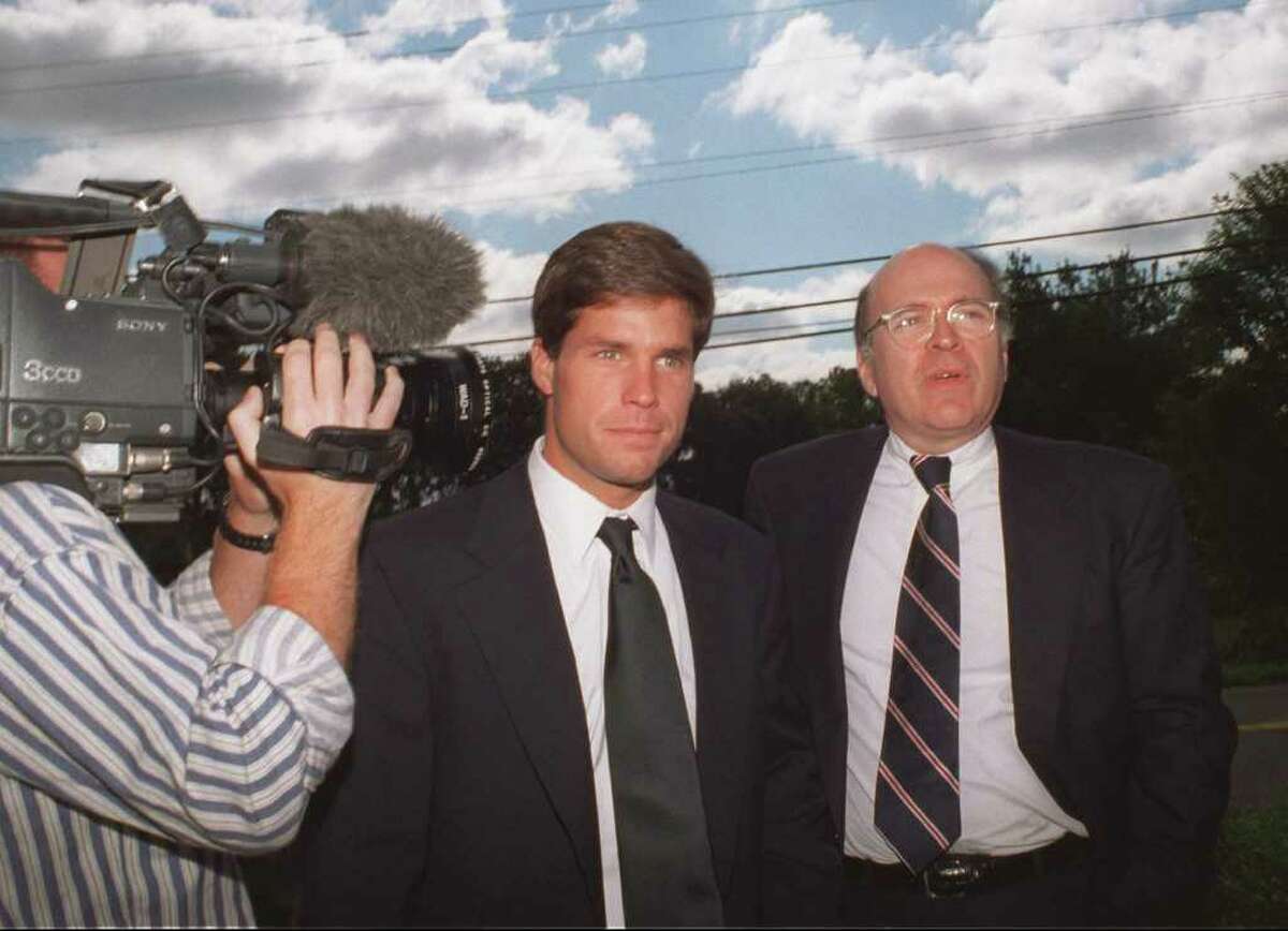 Double rape suspect Alex Kelly, escorted by his attorney Thomas Puccio, right, walks to the Darien, Conn., police headquarters Monday, Sept. 23, 1996, to turn himself in following a weekend car accident that left a woman hospitalized. Puccio died Monday, March 12, 2012 of leukemia in New Haven, Conn. He was 67.