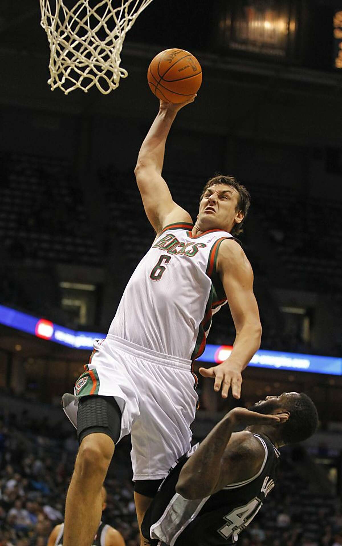 FILE - In this Jan. 10, 2012 file photo, Milwaukee Bucks' Andrew Bogut (6) dunks over San Antonio Spurs' DeJuan Blair during the second half of an NBA basketball game, in Milwaukee. The Bucks traded Bogut and Stephen Jackson to the Golden State Warriors on Tuesday night, March 13, 2012, for a three-player package headed by high-scoring guard Monta Ellis. (AP Photo/Jeffrey Phelps, File)