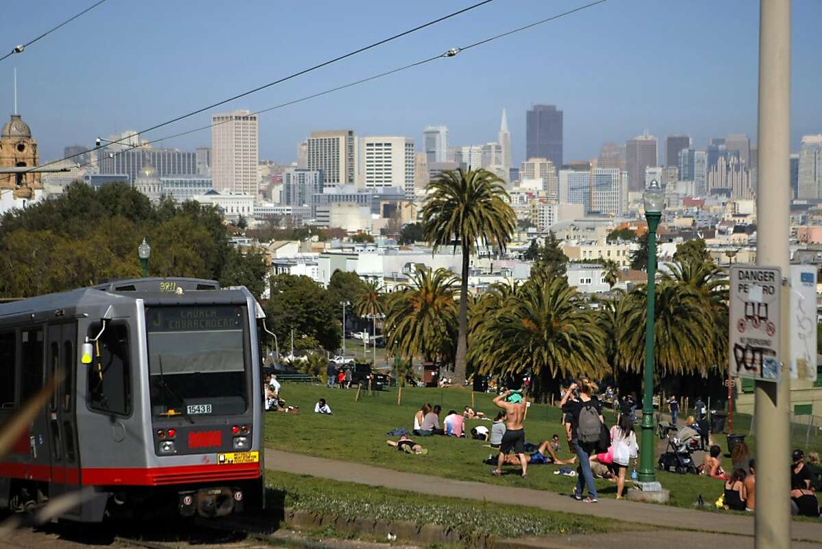 The J Church MUNI line drives by the Dolores Park in San Francisco, Calif. on Friday, March 9, 2012.