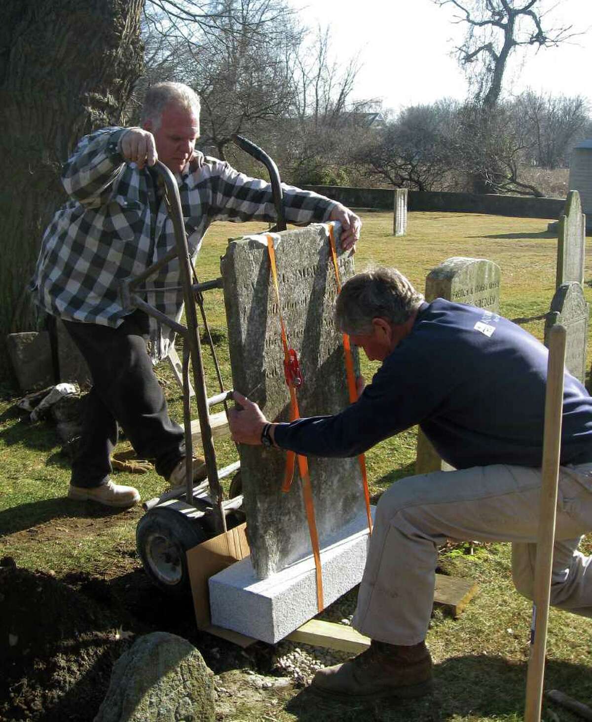 The repaired headstone for Capt. Samuel Smedley it put back in place at the Old Burying Ground on Beach Road recently.