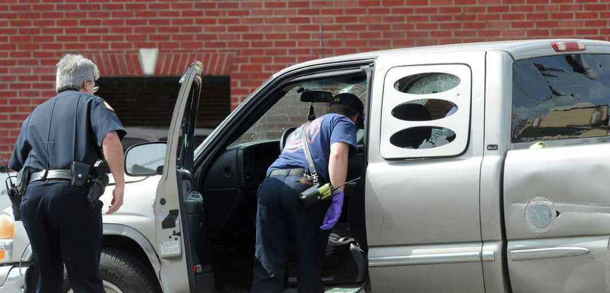Emergency personnel look through a truck driven by alleged gunman Bartholomew Granger after a shooting at the Jefferson County Courthouse in Beaumont on Wednesday, March 14, 2012. Police stopped Granger's getaway by opening fire on him at the Milam Street and Park Street intersection.