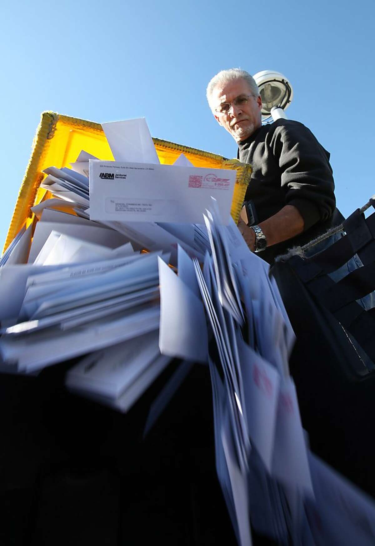 In this photo taken Feb. 24, 2012, mail deposited into outdoor postal boxes is collected for processing by postal worker Francisco Engelhard at the Sacramento Processing Center in West Sacramento, Calif. Elections officials in several states are concerned that the closing of mail-processing centers and post offices could disrupt vote-by-mail balloting this year.(AP Photo/Rich Pedroncelli)