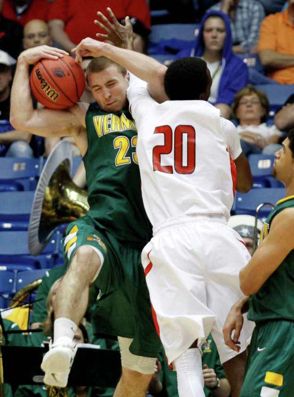Vermont forward Brian Voelkel (23) fights for a rebound with Lamar guard Brandon Davis (20) during the first half of an NCAA tournament first-round college basketball game, Wednesday, March 14, 2012, in Dayton, Ohio. (AP Photo/Skip Peterson)