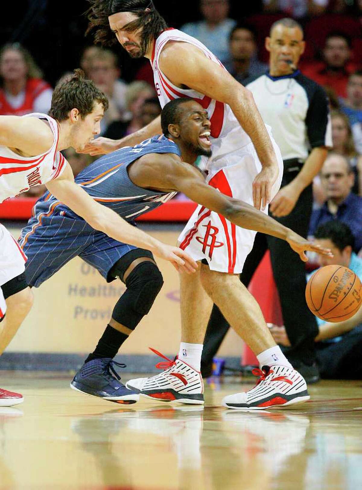 Houston Rockets point guard Goran Dragic (3) steals from Charlotte Bobcats point guard Kemba Walker (1) as Walker collides against Houston Rockets power forward Luis Scola (4) in the first period during the basketball game at Toyota Center on Wednesday, March 14, 2012, in Houston.