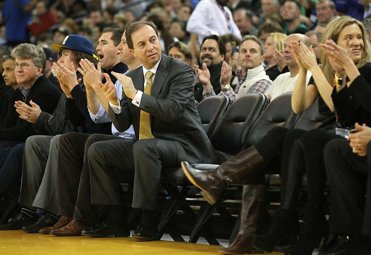 Golden State Warriors' majority owner Joe Lacob sits next to two vacant seats on the front row during their game with the Boston Celtics Wednesday, March 14, 2012, in Oakland.