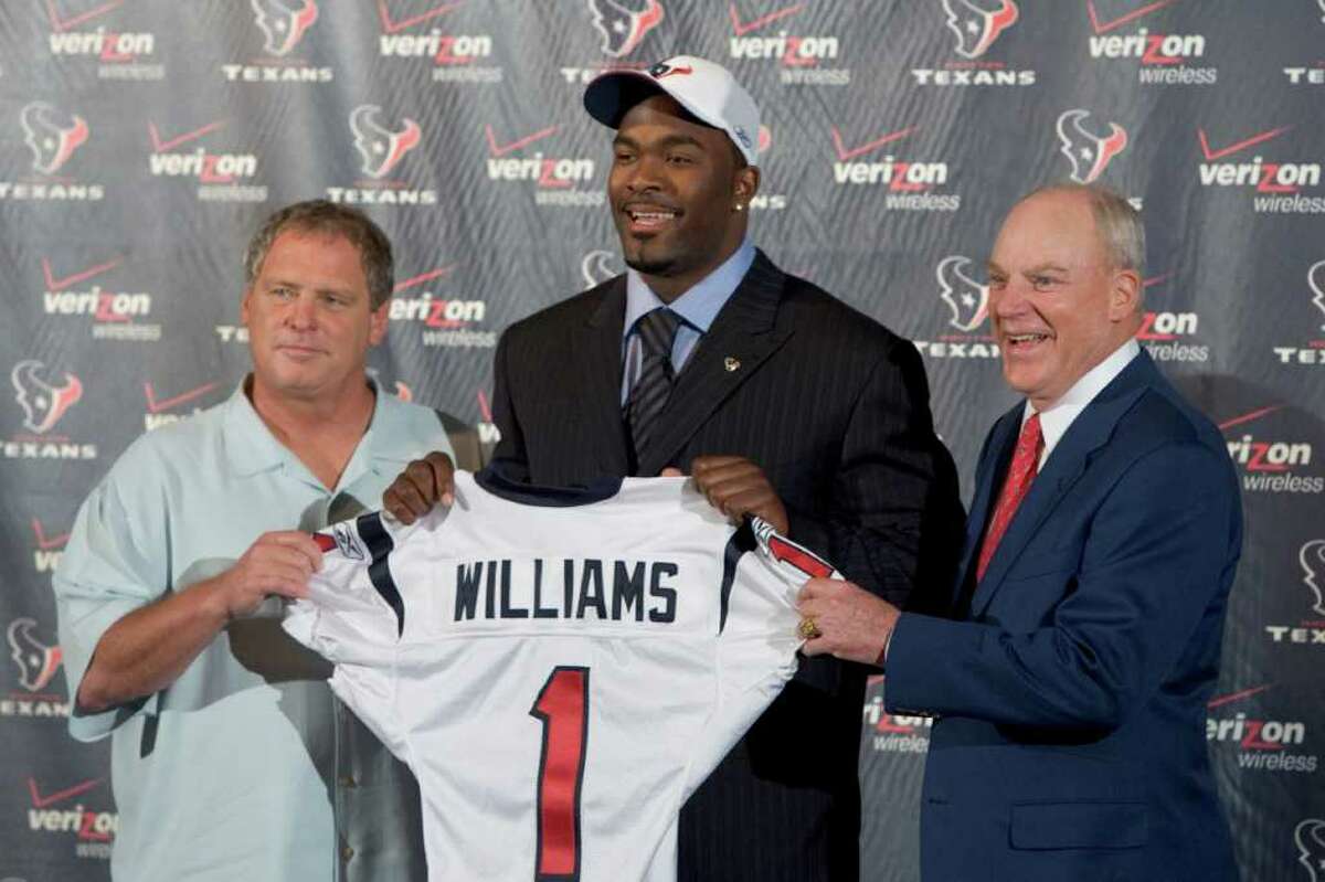 Houston Texans defensive coordinator Richard Smith, left, and team owner Bob McNair flank the newest Houston Texans player Mario Williams, a defensive end from North Carolina State, as they pose for photos upon arrival back in Houston after Williams was taken as the top pick in the National Football League Draft Saturday, April 29, 2006.