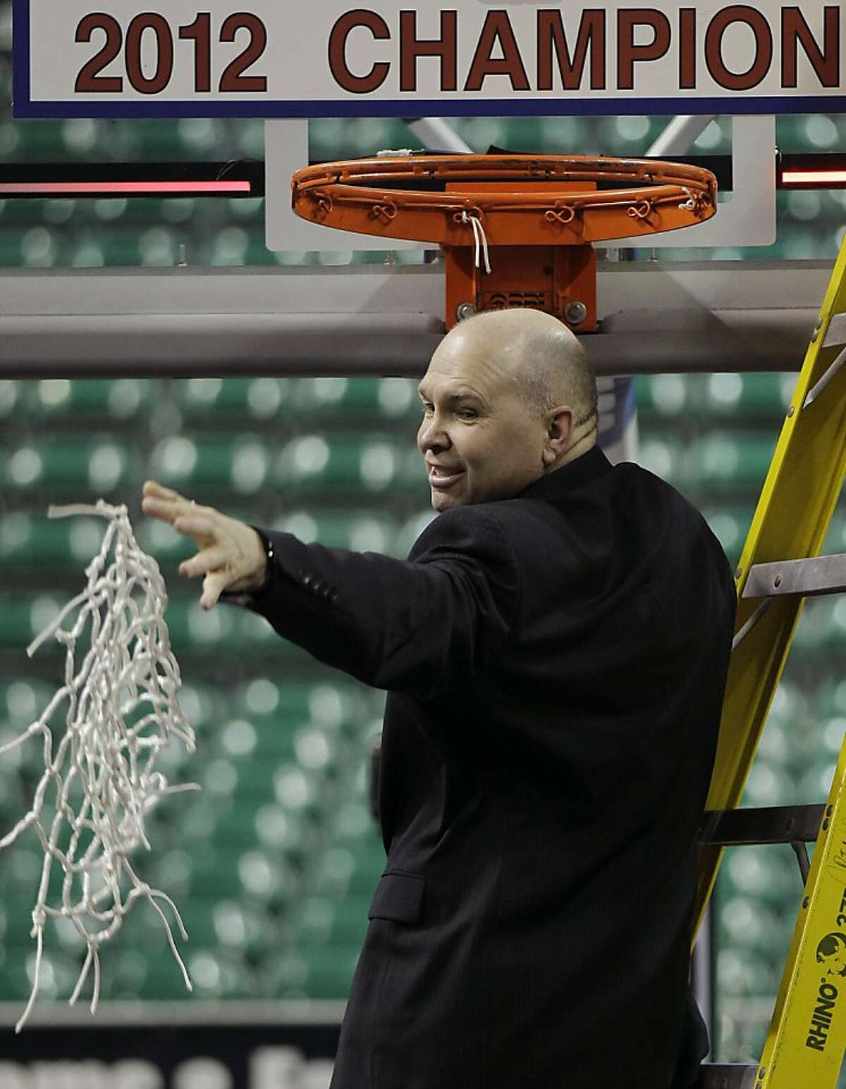 FILE - In this March 5, 2012, file photo, Saint Mary's coach Randy Bennett throws the net to his players after cutting it down after beating Gonzaga 78-74 in overtime in an NCAA college basketball game in the championship of the West Coast Conference tournament in Las Vegas. (AP Photo/Julie Jacobson, File)