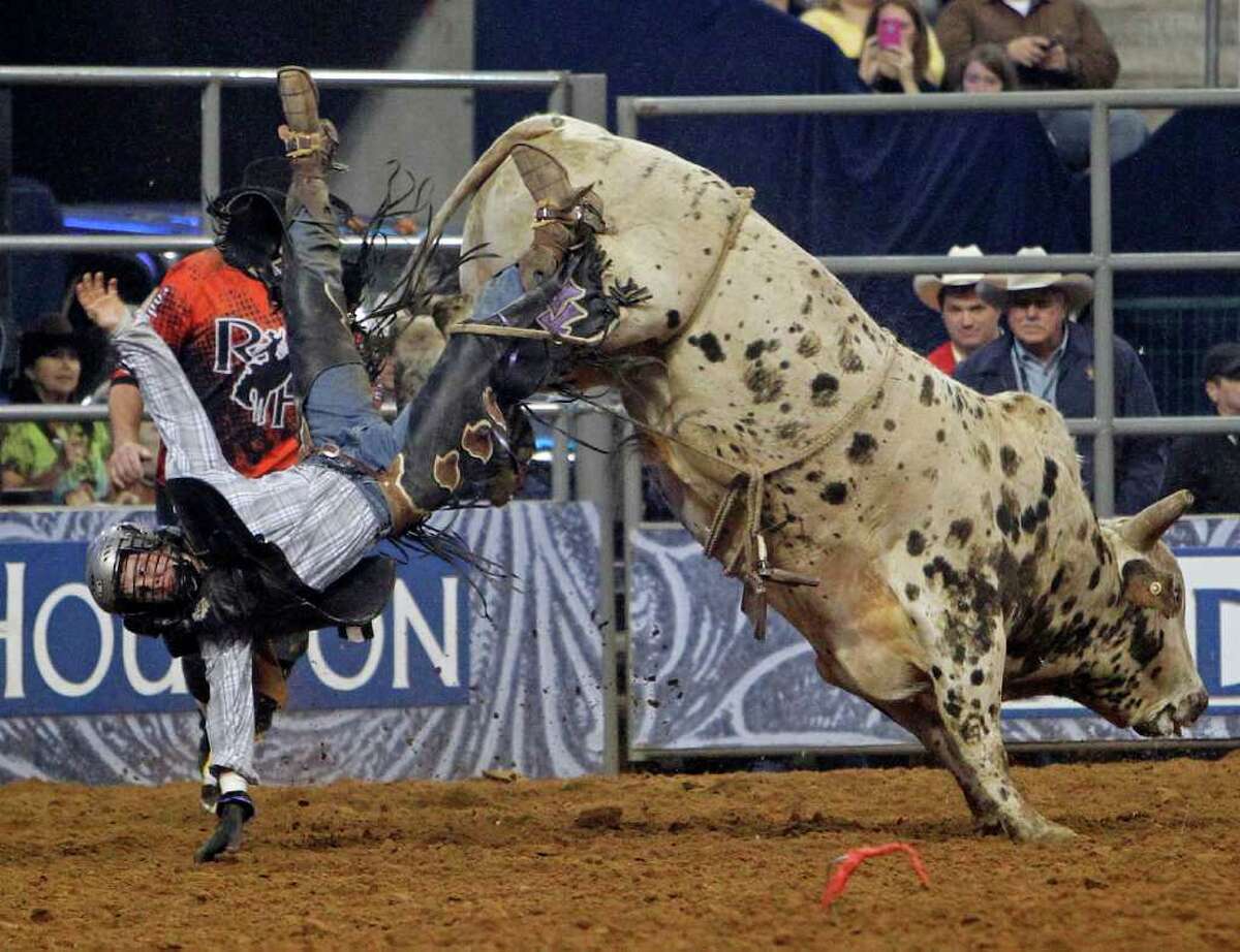 Although Trey Benton appears to be tossed from his bull, he completed his ride Thursday at RodeoHouston in Reliant Stadium.