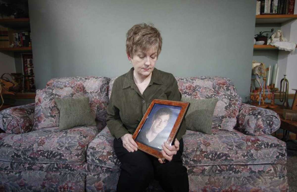 In this Monday, Feb. 27, 2012, photo, Karen Williams looks at a portrait of her son Loren Williams at her home in Beaverton, Ore. When Karen Williams' son died in a motorcycle crash, the Oregon woman turned to his Facebook account in hopes of learning more about the young man she had lost. Williams found his password and emailed the company, asking administrators to maintain 22-year-old Loren Williams' account so she could pore through his posts and comments by his friends. But within two hours, she said, Facebook changed the password, blocking her efforts.