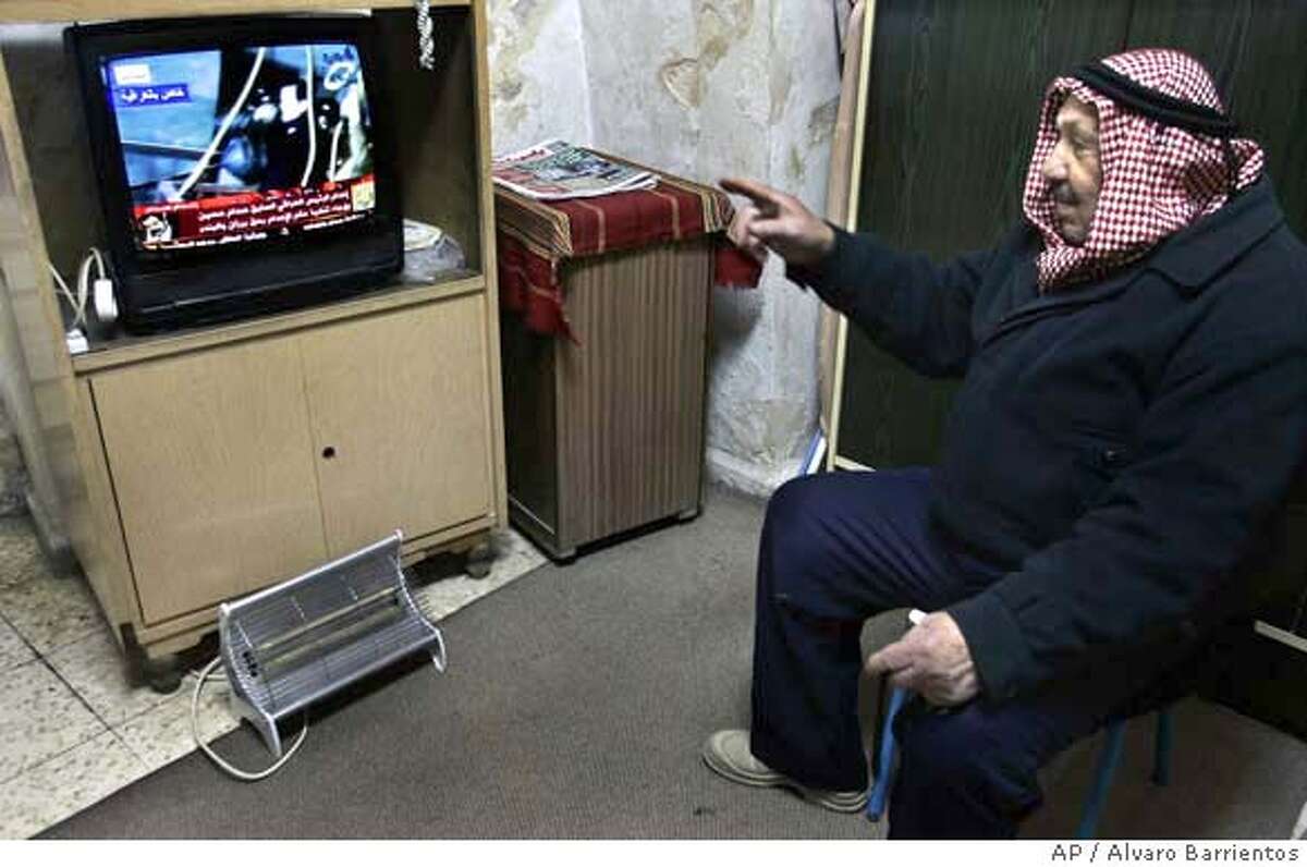 A Palestinian man watches details of the execution of former Iraqi president Saddam Hussein on television, in Jerusalem's Old City, Saturday, Dec. 30, 2006. The execution of Saddam Hussein sent many Palestinians into deep mourning Saturday as they struggled to come to terms with the demise of perhaps their most steadfast ally. Unlike much of the rest of the world, where Saddam was viewed as a brutal dictator who oppressed his people and started regional wars, in the West Bank and Gaza he was seen as a generous benefactor unafraid to fight for the Palestinian cause _ even to the end.(AP Photo/Alvaro Barrientos)