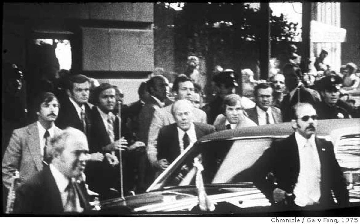 Pres. Gerald Ford Assination Attempt by Sarah Jane Moore at the St. Francis Hotel, Post St. entrance. Secret Service Agents hear a shot and grab Pres. Ford to push him in the armor protected limo. Photo by Gary Fong