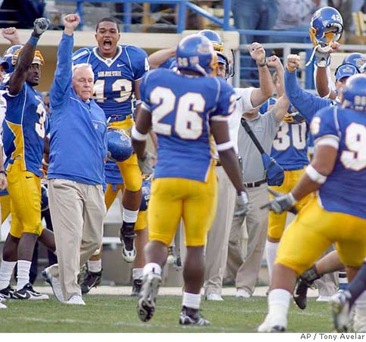 San Jose State coach Dick Tomey, left, raises his arm as his football team celebrates its 21-14 win over Utah State, Saturday, Oct. 14, 2006, in San Jose, Calif. (AP Photo/ Tony Avelar) EFE OUT