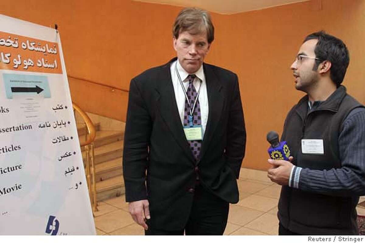 An Iranian journalist speaks with American David Duke (L), a former Ku Klux Klan leader, as he attends the international conference of 'Review of the Holocaust: Global Vision' in Tehran, December 12, 2006. Iran staged a conference on Monday to debate the Holocaust and question whether Nazi Germany used gas chambers, prompting charges it was encouraging the denial of the killing of 6 million Jews during World War Two. REUTERS/Stringer (IRAN) 0