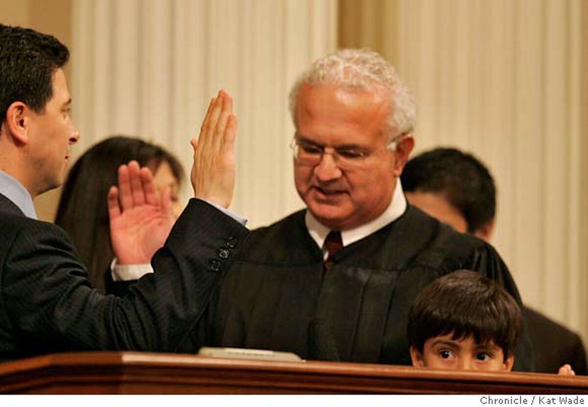 LEGISLATURE_0095_KW_.jpg While Carlos Nu�ez peeks over the podium (RIGHT), The Honorable Carlos R. Moreno (CENTER), associate Justice of the Supreme Court of California swears in his father, the re-elected Speaker of the California State Assembly, Fabian Nu�ez, 46th district on Monday December 4, 2006 in Sacramento newly elected assembly members are sworn at the official start of the new legislative session . Mandatory Credit for San Francisco Chronicle and photographer, Kat Wade, Mags out