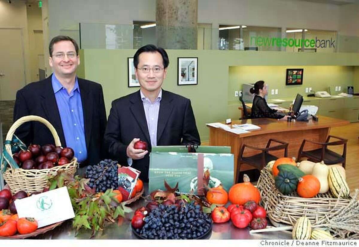 greenbank_0011_df.jpg (l to r) Clay Jones, President and CEO, and Peter Liu, Vice Chairman, of New Resource Bank are photographed in front of a display of fruits and vegetables from Marin Organic and Veritable Vegetable which are two companies New Resource Bank does business with. Photographed in San Francisco on 11/16/06. (Deanne Fitzmaurice/ The Chronicle) Mandatory credit for photographer and San Francisco Chronicle. /Magazines out.