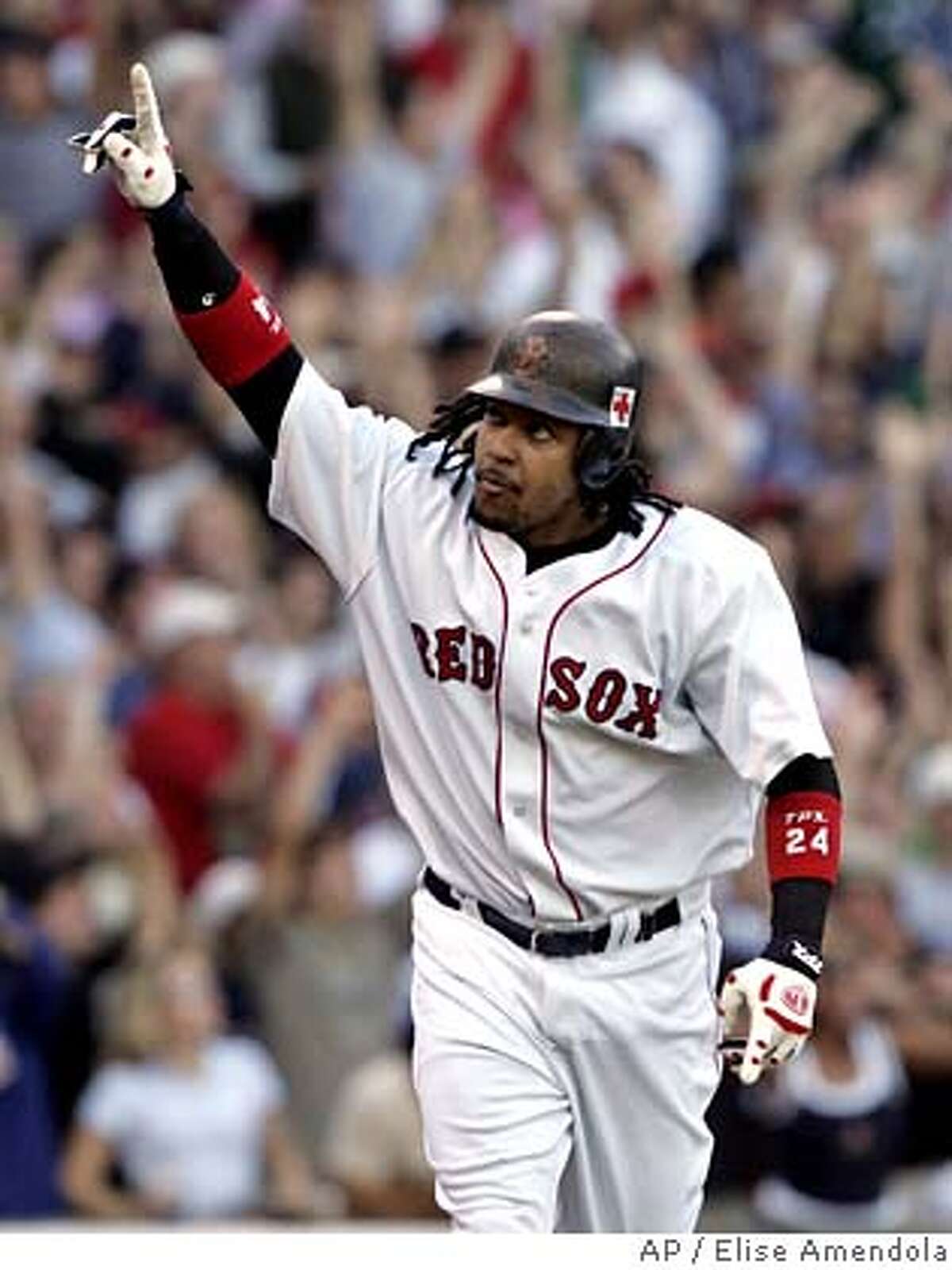 Boston Red Sox' Manny Ramirez rounds the bases after his three-run home run off New York Yankees pitcher Scott Proctor during the fourth inning at Fenway Park in Boston, Sunday, Oct. 2, 2005. At left is Yankees catcher Jorge Posada.(AP Photo/Elise Amendola) Ran on: 10-03-2005 Manny Ramirez rounds the bases after his three-run homer in a rout of the Yankees.