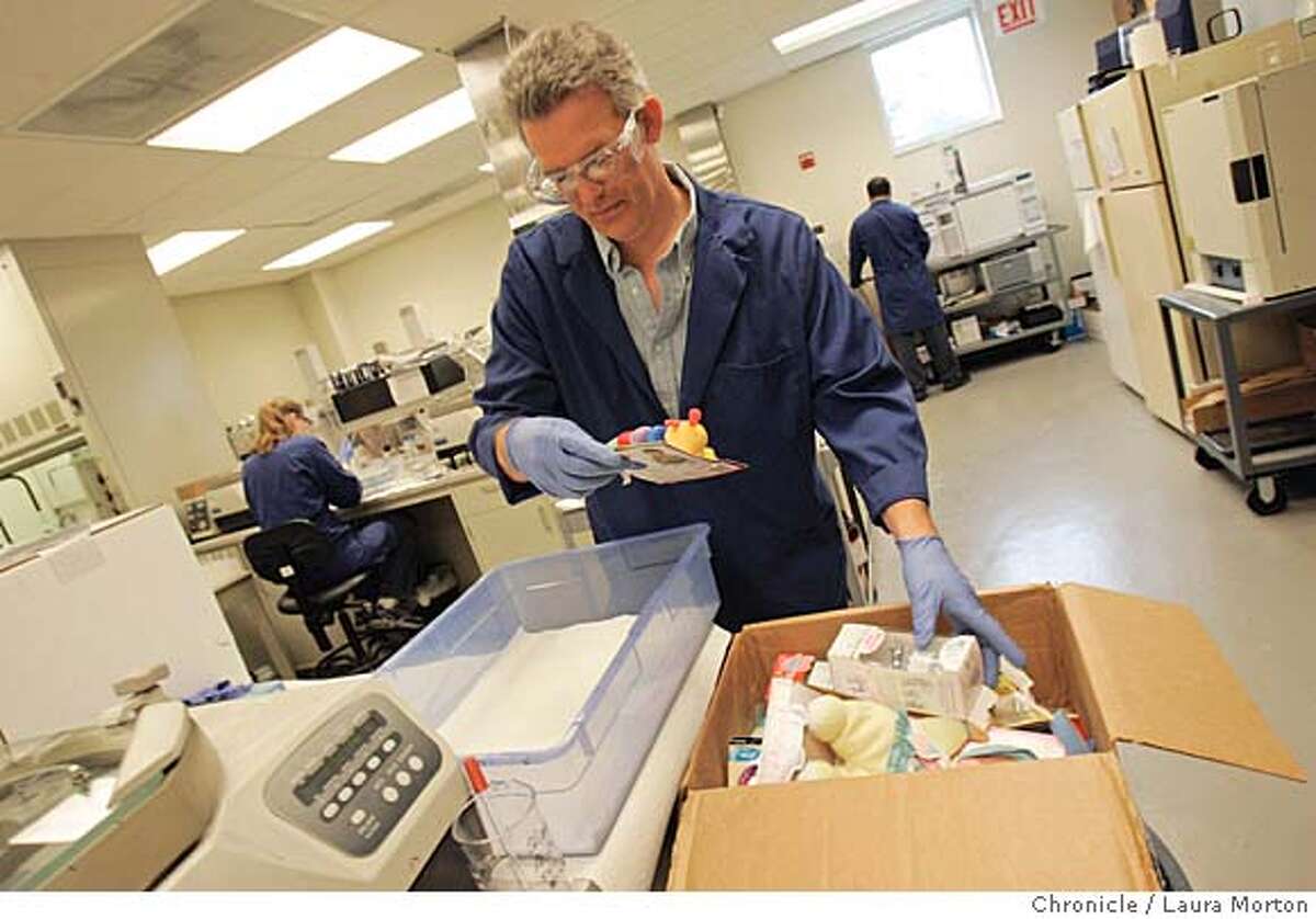 EDITED CAPTION: Jeremiah Favero looks at a opens a box of toys sent by The Chronicle to STAT Analysis Corp. in Chicago for testing in preparation of a new ordinance banning toys with bisphenol A and some levels of phthalates. ORIGINAL CAPTION: Jeremiah Favero choses from a box of toys to test for phthalates at STAT Analysis Corp. lab in Chicago. Laura Morton/The Chronicle