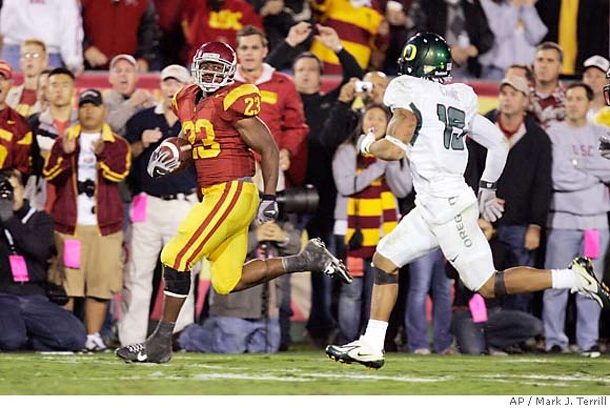 Southern California running back Chauncey Washington rushes for a 43-yard touchdown as Oregon cornerback Patrick Chung gives chase during the second half of a football game Saturday night, Nov. 11, 2006, in Los Angeles. (AP Photo/Mark J. Terrill) EFE OUT