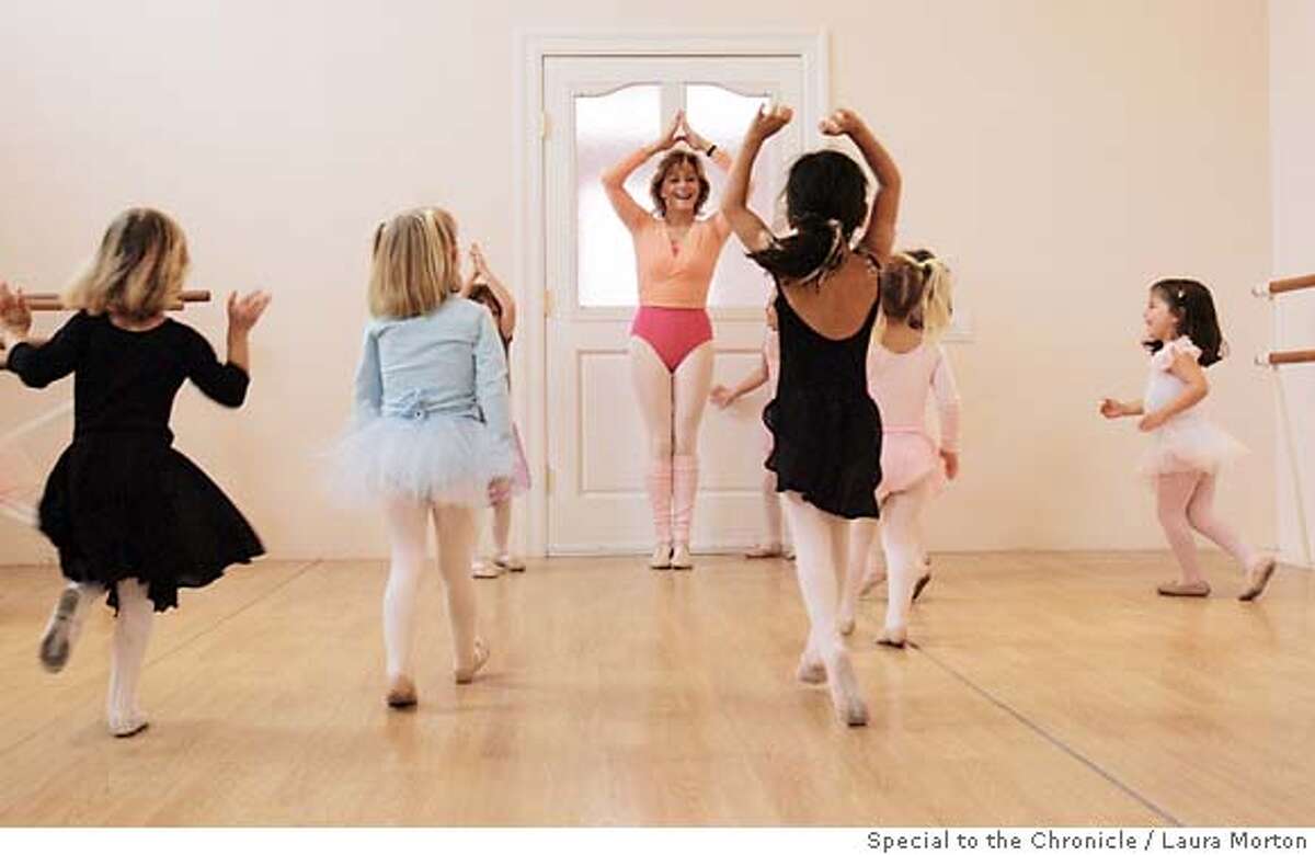 Tilly Abbe (center) leads her young students in a dance where they were instructed to act like Christmas trees at her San Francisco studio. Abbe has been teaching young girls ballet for over 30 years.