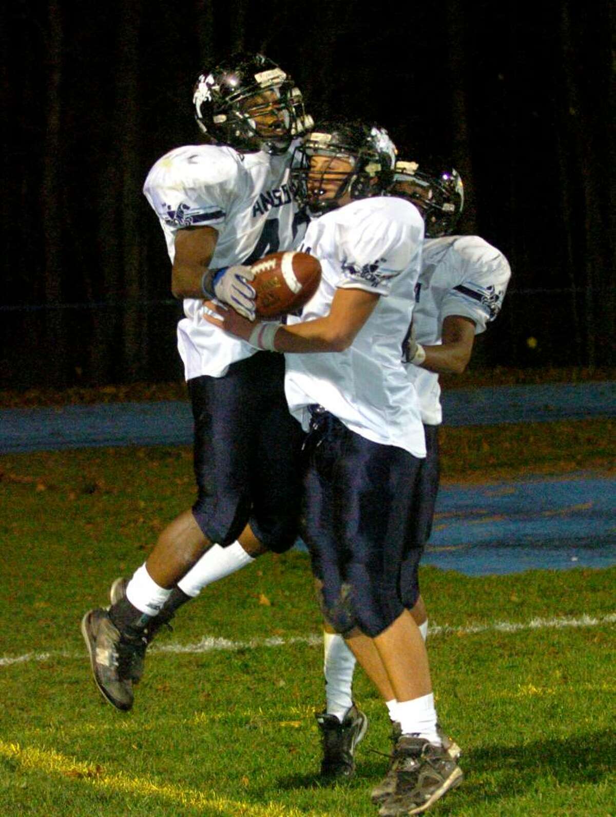Christian Abraham/Staff photographer Ansonia's #40 Robert Kinnebrew, left, leaps into teammate #82 Jake LaRovera's arms after a touchdown, during football action against Seymour in Seymour, Conn. on Thursday Nov. 12, 2009. Ansonia defeated Seymour 51-21.